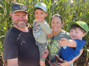 Dairy farmers Amber and Fraser Carpenter with sons Oliver and Noah.