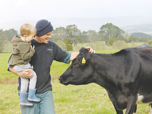 Jeremy Mounter and son Joe with one of their cows.
