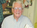 Author and former apple grower, Chris Smellie, signing copies of his book.