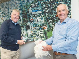 Palle Petersen of Bloch and Behrens (left) and general manager of PGG Wrightson Wool Grant Edwards inspect an Ege printed carpet taken from a photograph of the pre-quake Christchurch CBD.
