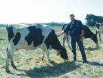 Australian farmer Mark Billing with a cow fitted with CowScout tag.