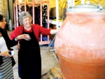 Mary Evans shows off the imported amphora to a cellar door visitor.