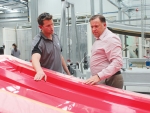 Waikato Milking Systems chief executive Dean Bell (right) and boatbuilder Josh Janmaat.