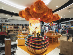 Comvita’s new Auckland airport store includes a large-scale hive ceiling feature which was created using 10,000 beeswax dipped fabric sheets.
