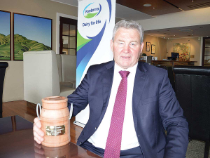 Former Fonterra chairman John Monaghan with his farewell gift from the Fonterra Shareholder&#039;s Council - a wooden cream can carved from a Totara post.