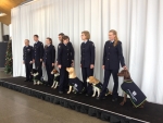 Five of the twenty-four new biosecurity detector dog teams graduating.