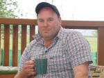 Associate Agriculture Minister Andrew Hoggard enjoys a tea break on his farm.