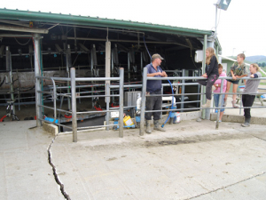 The Galletly family with their damaged rotary dairy shed. 