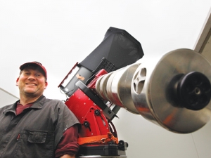 Oxford farmer Stu Parker with his 16-inch telescope he uses to scan the sky for supernovas.