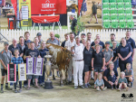 Supreme Champion Exhibit of the show Kiteroa Cream Bubbette with her banners and the team that made it happen. Photo Credit: Sheila Sundborg (Canada).