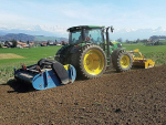 Spading mixes organic material by working crop residues and green manure into the soil to prepare a seedbed ready for planting.