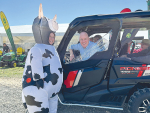 Prime Minister Christopher Luxon meeting Lucy the inflatable cow at Southern Field Days.