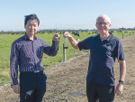 Lincoln University Professors Hong Di (left) and Keith Cameron show bottles of effluent, one raw and one cleared by the coagulant used in ClearTech system.