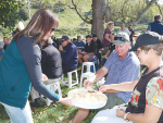 Anne-Marie Case-Miller, SMASH organising committee member, hands out cheese at the field day.