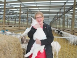Associate Primary Industries Minister Jo Goodhew with a kid at the new Oete farm.