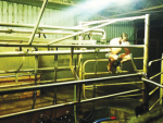 Australian dairy farmer Adam Nelson in his empty dairy.